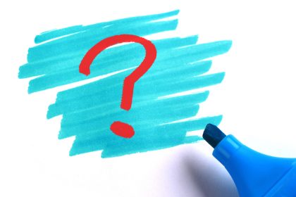 Question mark with blue marker on white background.